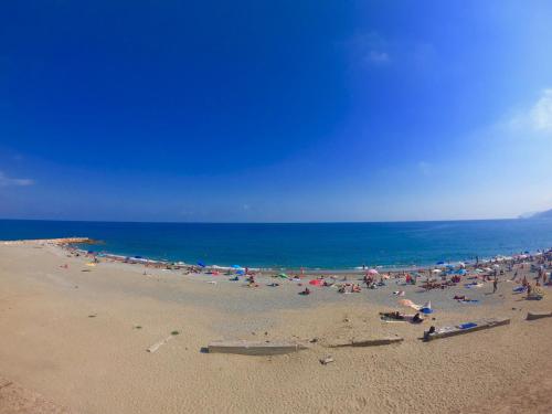 a large group of people on a beach at Central Savona in Savona
