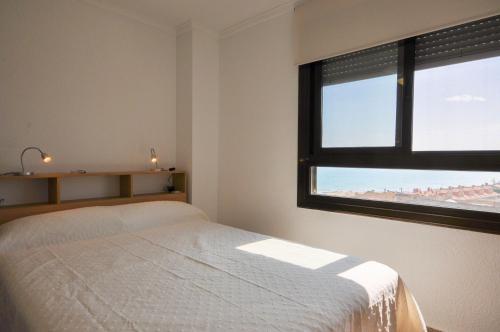 A bed or beds in a room at 7th floor beachfront apartment with stunning views