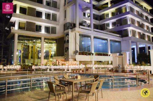 a restaurant with a table and chairs in front of a building at Pride Premier Solitaire in Dehradun