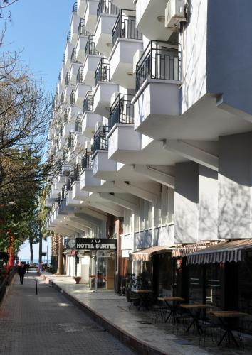 a building with balconies on the side of a street at Surtel Hotel in Kusadası