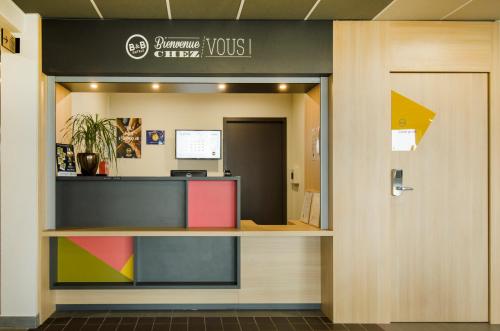 an entrance to a dental office with a reception desk at B&B HOTEL Montargis-Amilly in Amilly