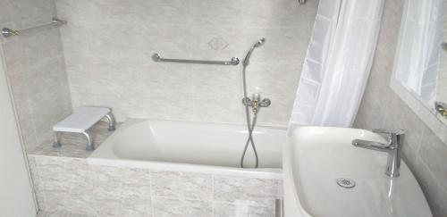 a bathroom with a white tub and a toilet at Love 2 Solkan in Nova Gorica