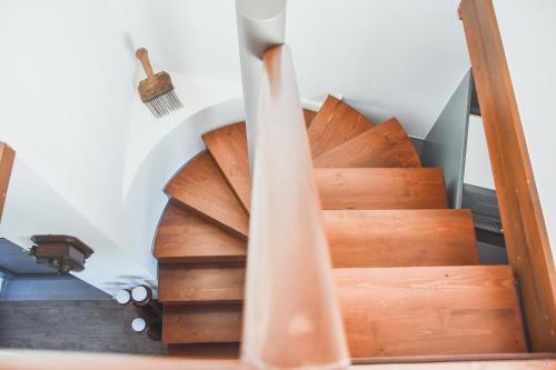 a set of wooden stairs with a wooden hand rail at Athivoli Elegant Apartments in Káto Metókhion