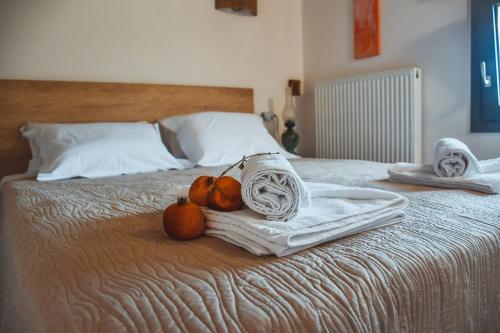 a bed with towels and pumpkins on top of it at Athivoli Elegant Apartments in Káto Metókhion