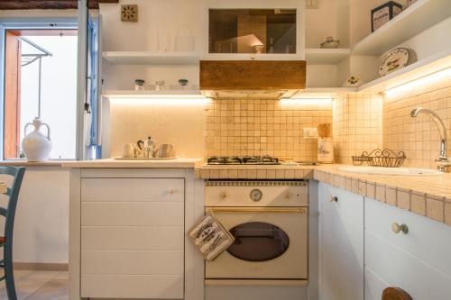 a kitchen with a stove and a dishwasher at Trulli&Dimore - Casa Reina in Polignano a Mare