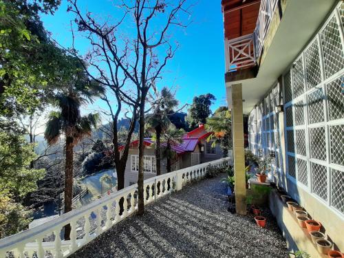 a balcony of a house with a view of a river at Abbotsford Prasada Bhawan in Nainital