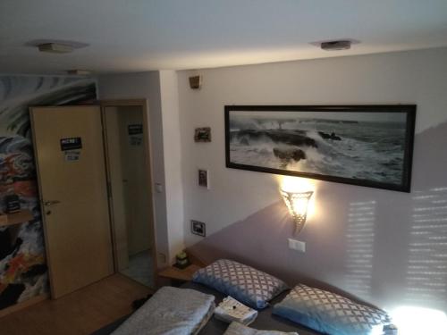 a room with a bed and a picture on the wall at MichoArt in Ljubljana