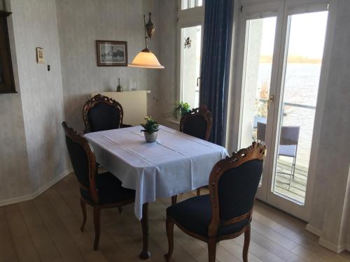 a dining room table with chairs and a white table cloth at Hotel Ambiente in Brake