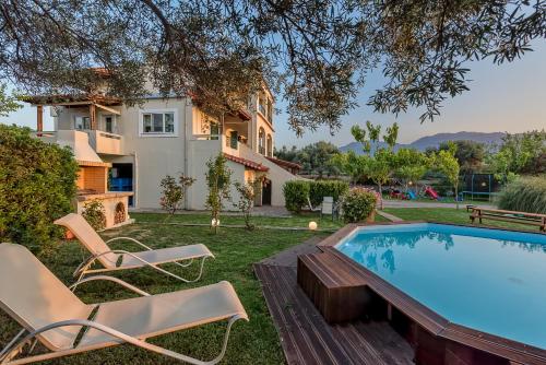 a villa with a swimming pool and a house at Malena Organic Farm in Episkopí- Rethimno