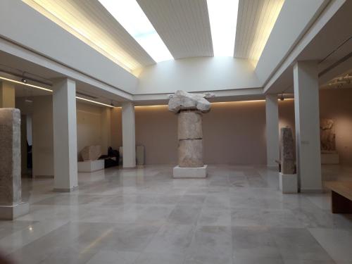 a room with a column in a museum with a window at Marathon Beachside Villa 100m from the beach in Schinias