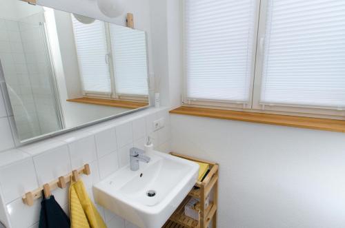 a bathroom with a sink and a mirror at FeWo 2 Markranstädt in Markranstädt