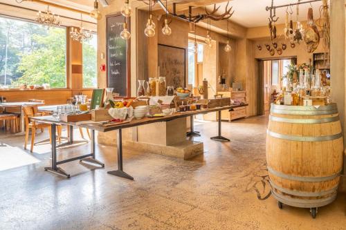 a wine tasting room with a table and a barrel at Apart Hotel Wetterhorn in Hasliberg
