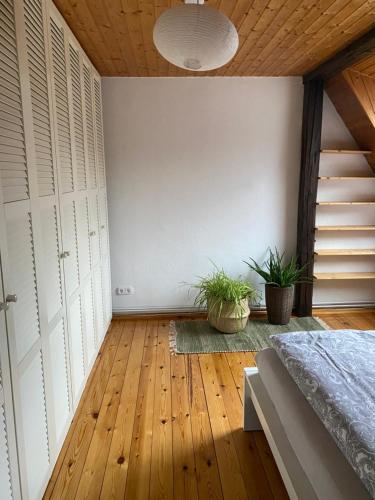 a bedroom with a bed and a wooden floor at Ferienwohnung Kanalblick in Schacht-Audorf