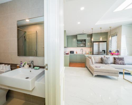 a living room and kitchen with a sink and a couch at RiverGate Residence in Ho Chi Minh City