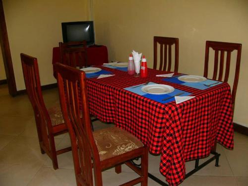 a table with a red and white checkered table cloth at Bright Star Hotel in Arusha