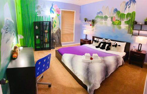 a bedroom with a large bed with penguins on it at Robinwood condominiums in Norcross