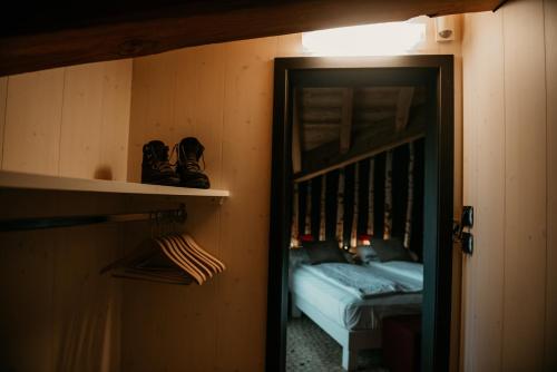 a room with a bed and a door to a bedroom at Alpen Hotel Chalet in Valdidentro