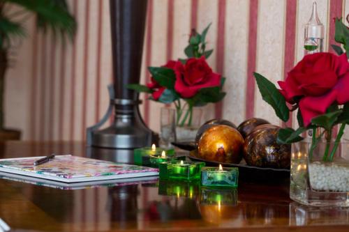 a table with flowers and candles on a table at The Sands Hotel in Paignton