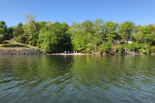 a large body of water with trees in the background at Spacious Home with Deck on Shores of Lake Wylie in York