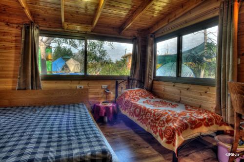 a bedroom with a bed in a room with windows at Country lodging in Manot in Manot