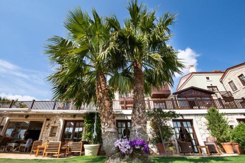 two palm trees in front of a building at Alacati Kapari Hotel - Special Category in Alacati