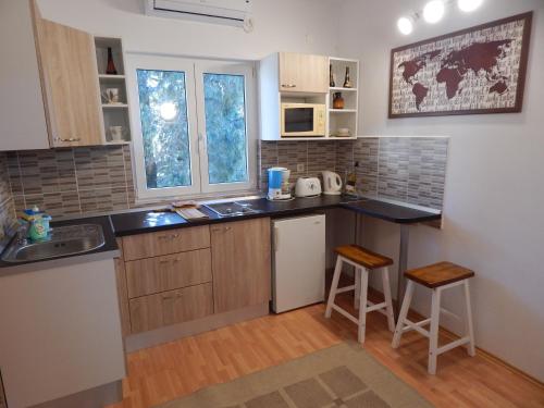 a kitchen with a sink and a counter top at Adrienn Apartments in Stari Grad
