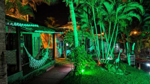 a house with green lights in front of a house at ThalassaGarden Hotel - Pousada in Pipa