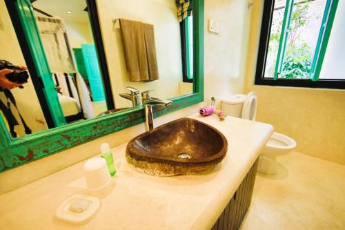 
a sink in a bathroom with a mirror above it at Parawa House in Galle
