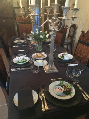 a black table with plates of food on it at Chateau Mareuil in Brigueuil-le-Chantre