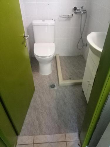 a bathroom with a toilet and a sink at Irinis Cottage in Kala Nera