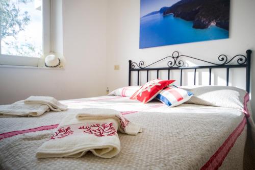 a bedroom with two beds with towels on them at Casa Delta delle Acque Vista spettacolare e Giardino in Cala Gonone