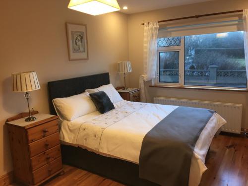 a bedroom with a large bed and a window at Atlantic View House in Killybegs