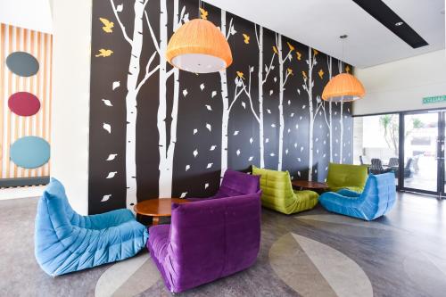 a room with chairs and a table and trees at Kisetsu no ie, KLCC Kuala Lumpur in Kuala Lumpur