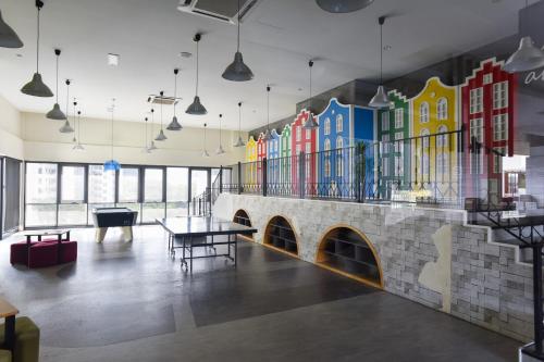 a room with a mural of buildings on the wall at Kisetsu no ie, KLCC Kuala Lumpur in Kuala Lumpur