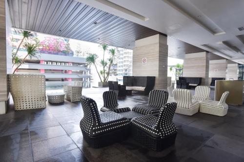 a lobby with chairs and tables in a building at Kisetsu no ie, KLCC Kuala Lumpur in Kuala Lumpur