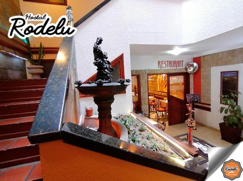 a water fountain in the middle of a house at Hotel Rodelu in Latacunga
