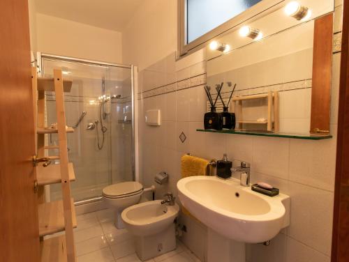 a bathroom with a sink and a toilet and a shower at Casa Pineta in Diano Marina