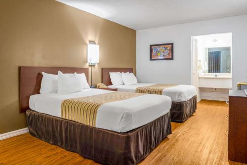 a hotel room with two beds and a window at Econo Lodge in Crystal River