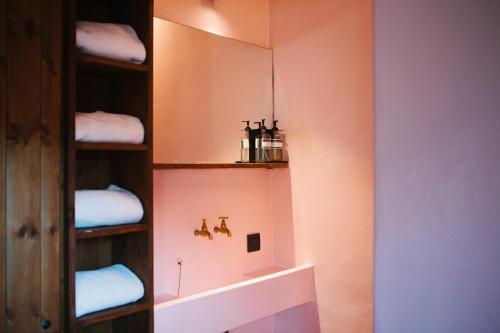 a bathroom with a shelf with towels on it at Friday Gent in Ghent