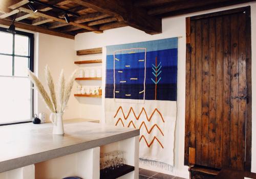 a kitchen with a large painting on the wall at Friday Gent, Exclusive Charming Guesthouse in Ghent