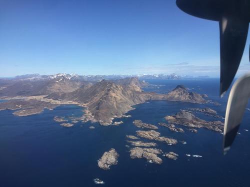 an island in the middle of the water from an airplane at Fishermans Dock Lofoten in Ballstad
