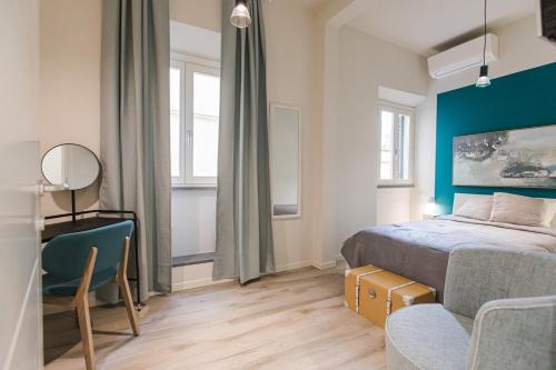 a bedroom with a bed and a desk and a chair at ROOMS LibertyHouse Firenze in Florence