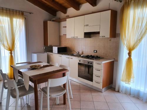 a kitchen with a table and a stove top oven at Il Borghetto in Lonigo