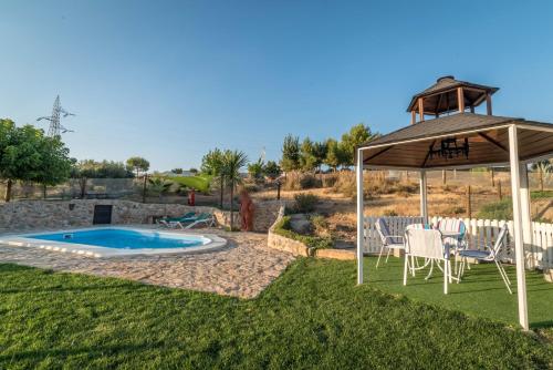 a backyard with a pool and a gazebo at Al Agia - Mirador de los Quinientos in Padul