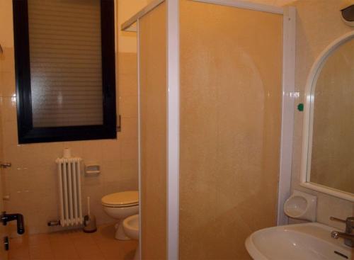 a bathroom with a shower and a toilet and a sink at Villaggio Accademia in Cesenatico