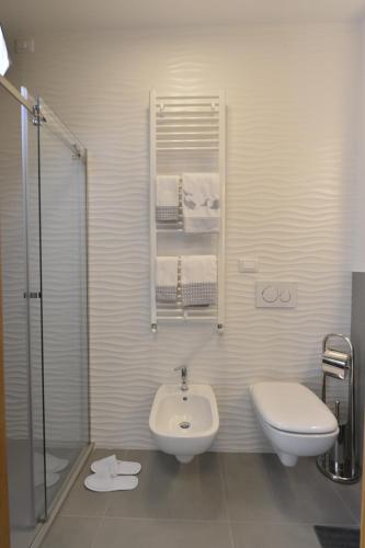 a bathroom with a sink and a toilet and a shower at Piano Alto Rooms in Pescara