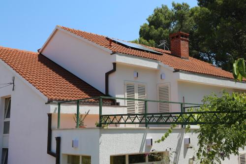 a white building with a red roof and a balcony at Apartment Markorcula in Korčula