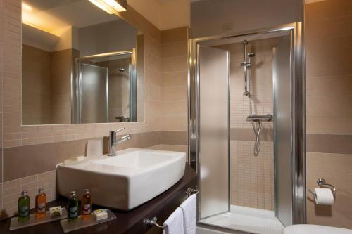 a bathroom with a sink and a shower at Il Teatro in Lido di Jesolo