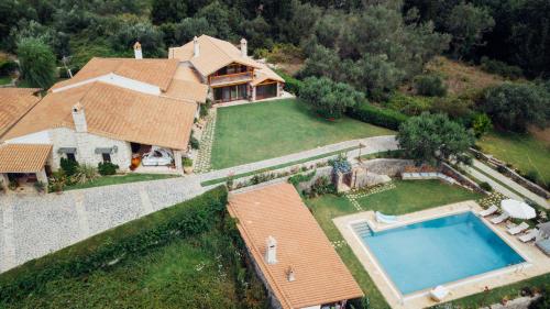 an aerial view of a house with a swimming pool at Villa Madera by CorfuEscapes in Kompítsion