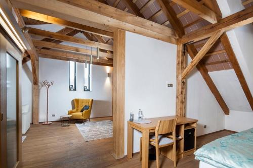 a room with a table and a chair in a room at Kaštieľ Kubínyi in Dolný Kubín